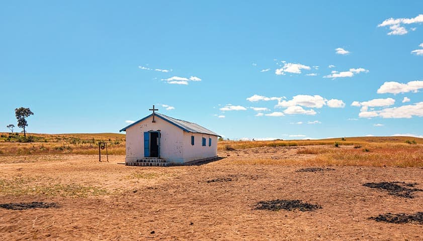 Lonely white single small chapel at flat African land away from Ilakaka town, on a sunny day